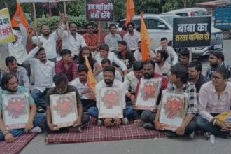Devotees and villagers sitting on a peaceful protest at Collector Chauraha with placards supporting Baba Bhootnath Mandir, highlighting the Indore and Rangwasa location.