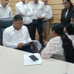 Collector Shivam Verma interacting with citizens during Jansunwai at Indore Collector Office, officials reviewing applications and public grievance redressal process in progress