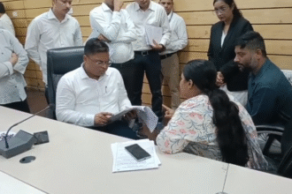 Collector Shivam Verma interacting with citizens during Jansunwai at Indore Collector Office, officials reviewing applications and public grievance redressal process in progress