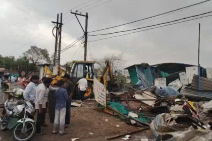 Revenue officials, municipal corporation team and police personnel conducting encroachment removal action in Bank Gram, Malharganj, with government land clearance visuals.