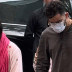Virat Kohli and Anushka Sharma walking in Vrindavan near Keli Kunj Ashram with devotional atmosphere, temple architecture and spiritual surroundings.