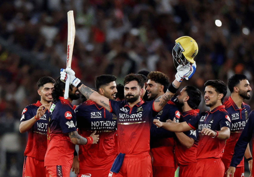 Virat Kohli holding the IPL trophy with RCB players celebrating at Narendra Modi Stadium, confetti in the background and championship moment focus.
